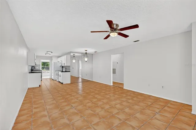 a view of a livingroom with a ceiling fan and window