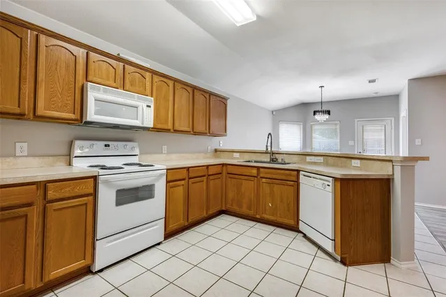 a kitchen with stainless steel appliances granite countertop a stove sink and cabinets