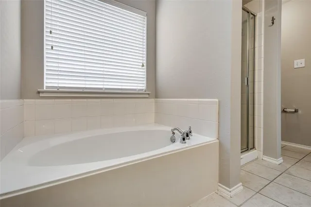a white bath tub sitting next to a window