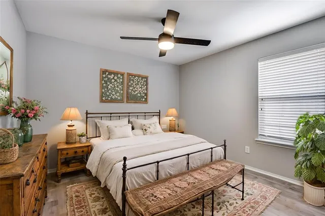 a bedroom with a bed and a potted plant