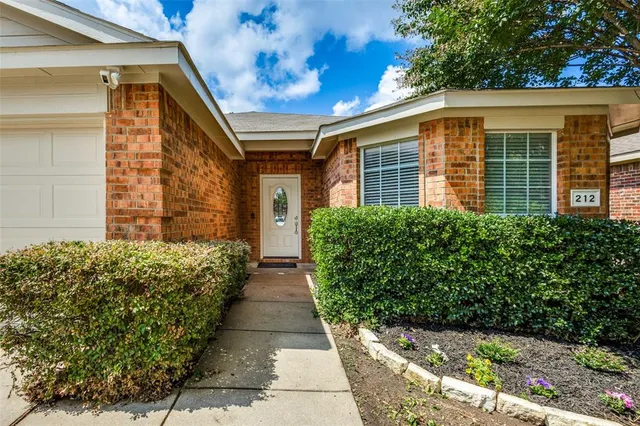 a view of a house with potted plants