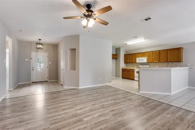 a view of a kitchen with a microwave and a ceiling fan