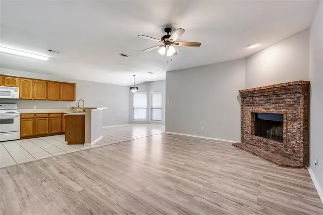 a view of a kitchen with a microwave and a stove top oven
