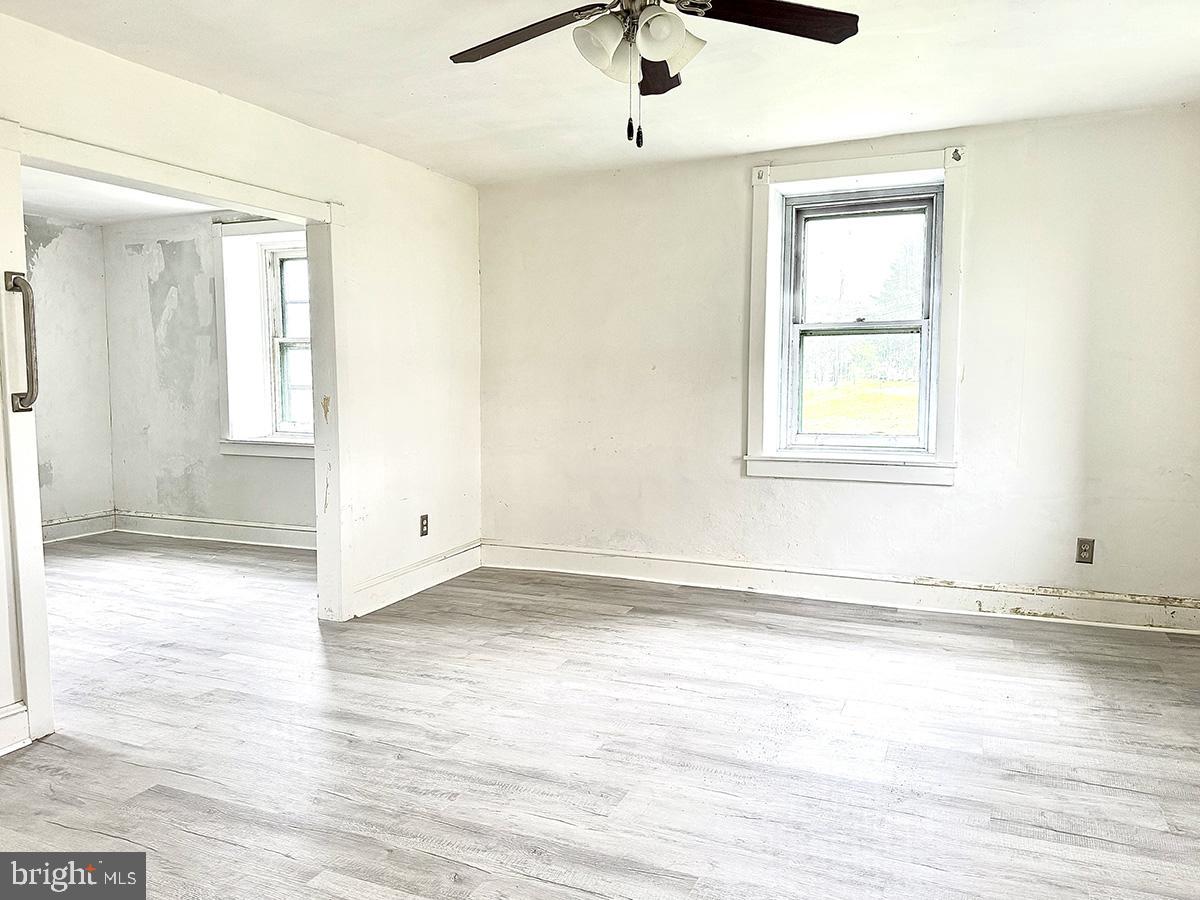 133 Hunter Road Oley, PA 19547 - Photo 13 of 44 an empty room with wooden floor and windows