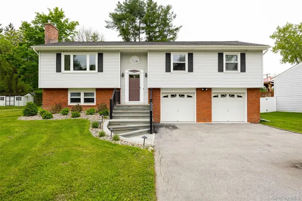 a front view of a house with a yard and garage