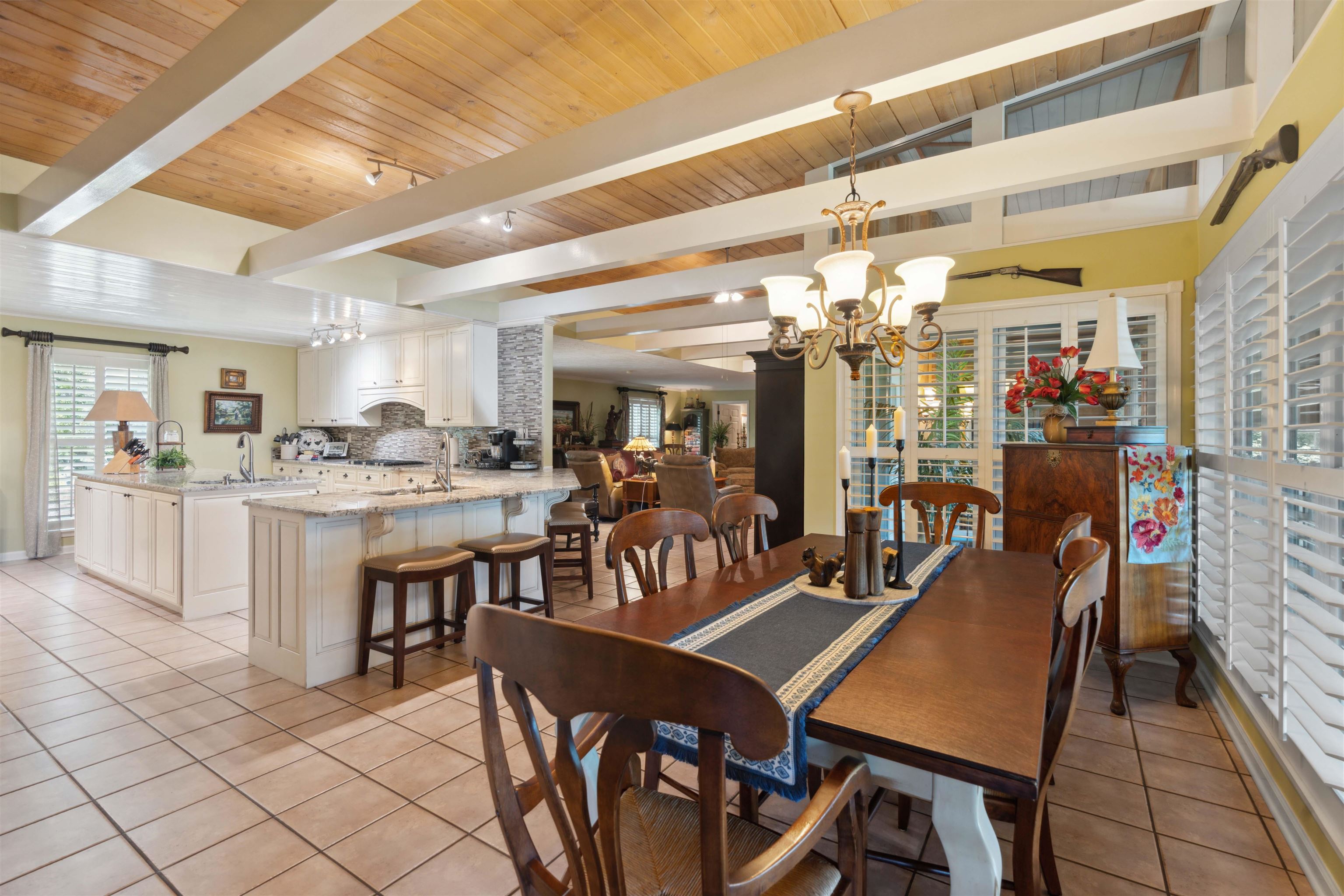 155 Carlins Road Hornsby, TN 38044 - Photo 16 of 40 Dining room featuring an inviting chandelier, sink, beamed ceiling, and light tile patterned flooring