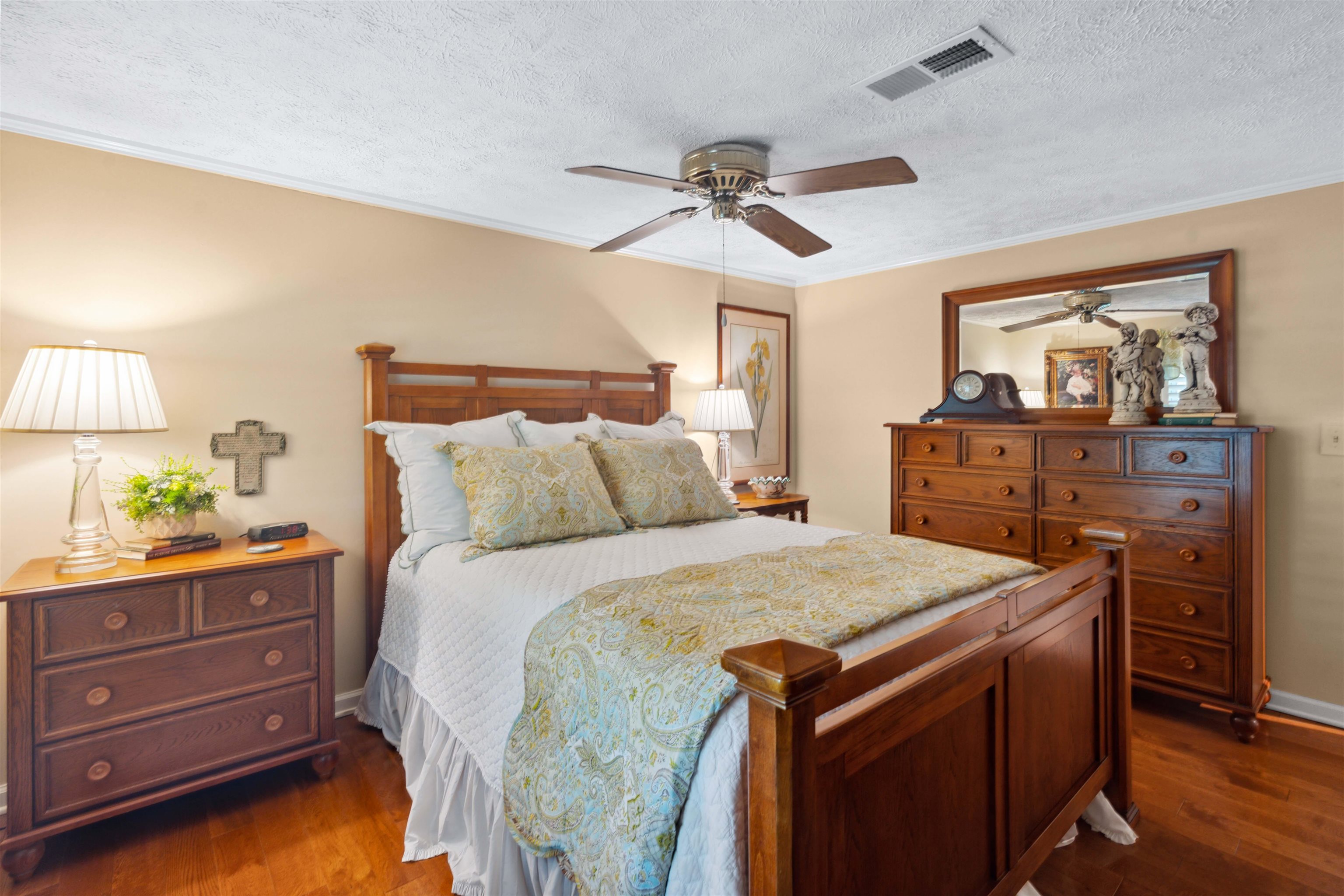 155 Carlins Road Hornsby, TN 38044 - Photo 18 of 40 Bedroom featuring ceiling fan, crown molding, a textured ceiling, and dark hardwood / wood-style flooring