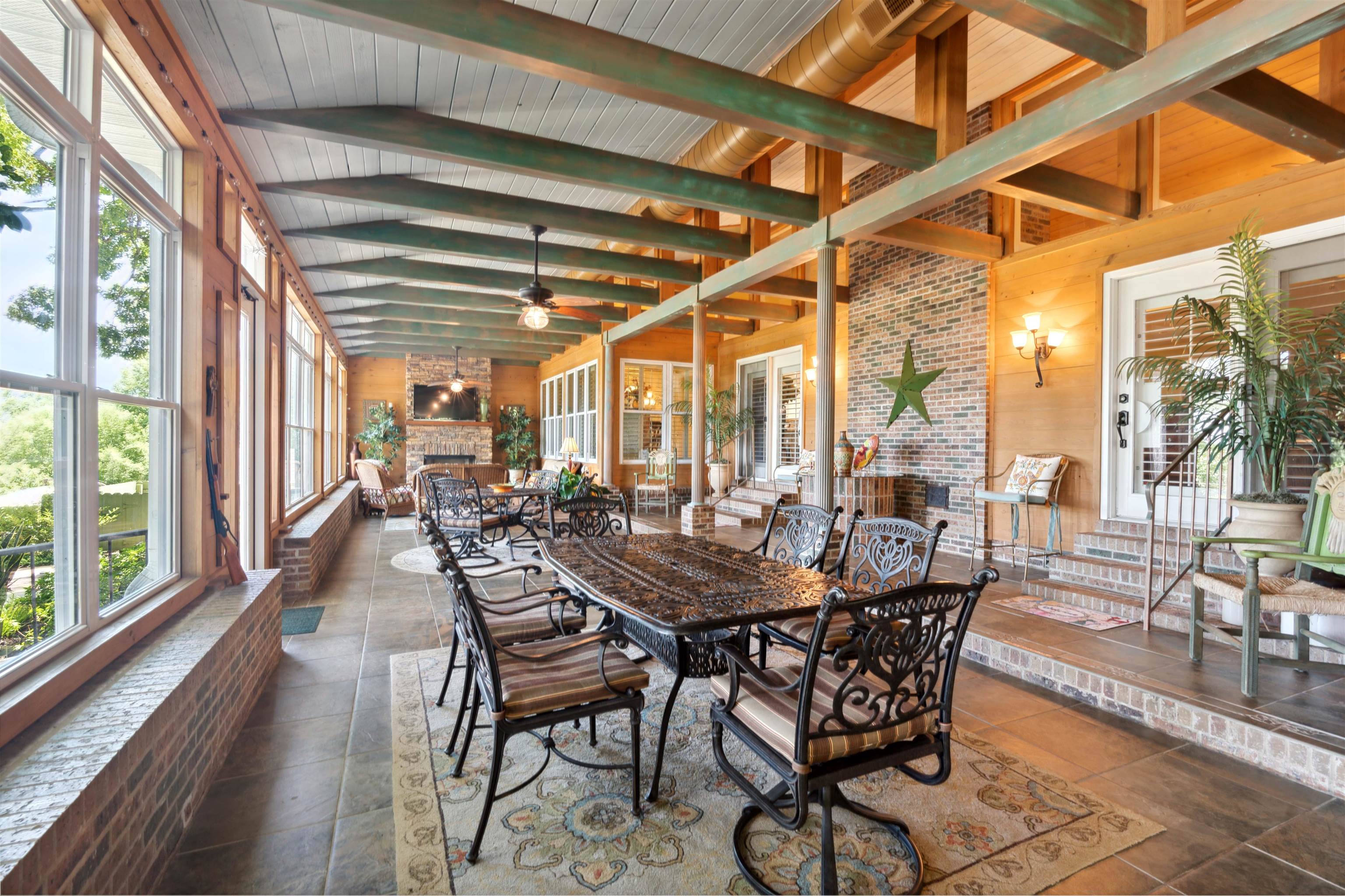 155 Carlins Road Hornsby, TN 38044 - Photo 30 of 40 Sunroom / solarium featuring ceiling fan, lofted ceiling with beams, wood ceiling, and a large fireplace