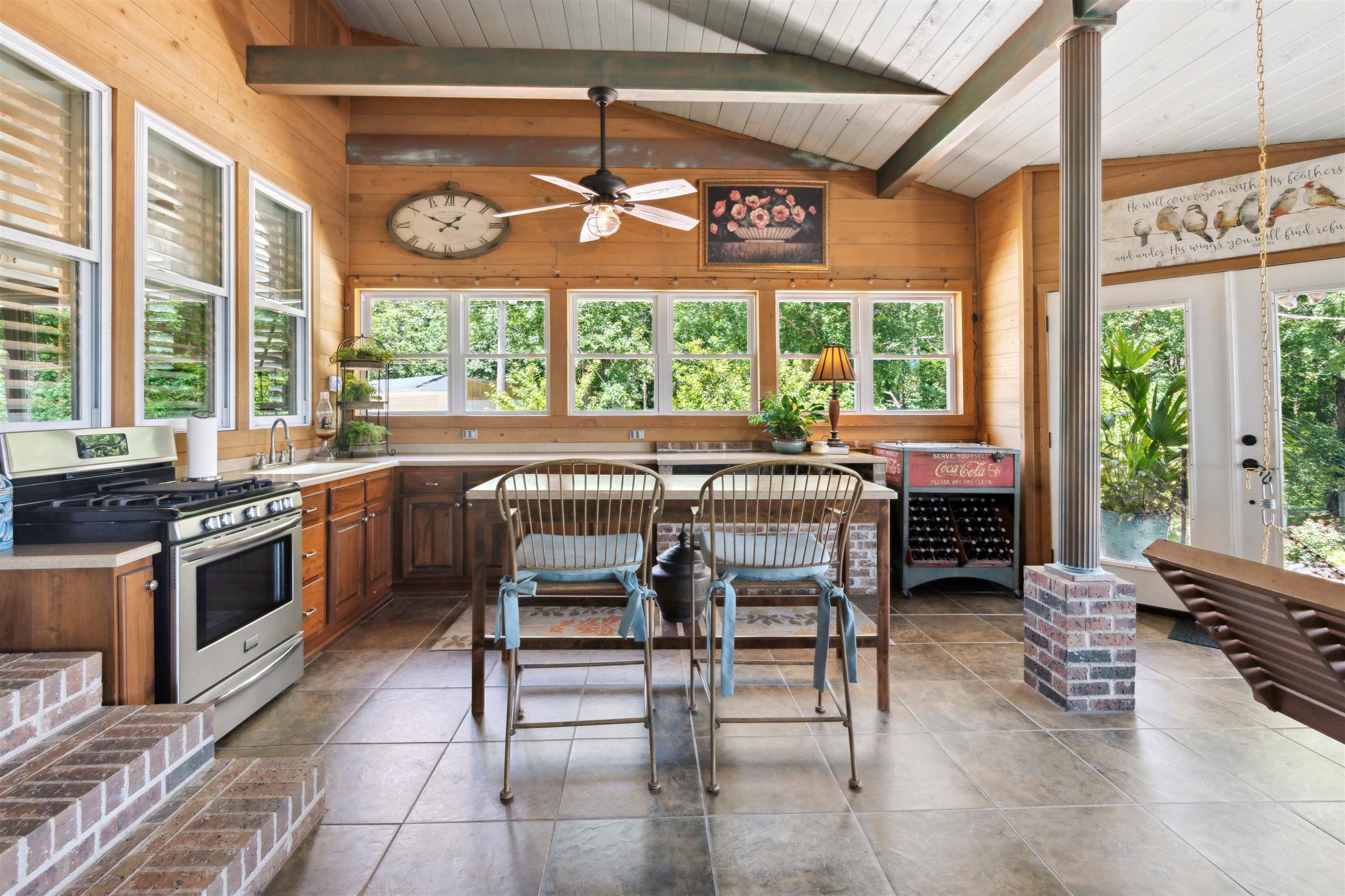 155 Carlins Road Hornsby, TN 38044 - Photo 35 of 40 Kitchen featuring vaulted ceiling with beams, wooden walls, tile patterned flooring, stainless steel gas range oven, and ceiling fan