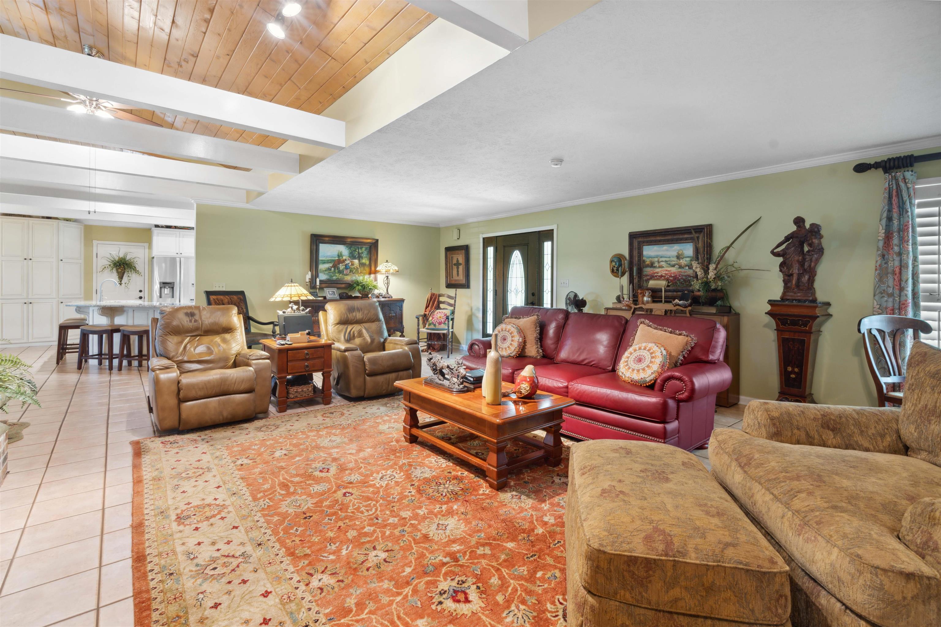 155 Carlins Road Hornsby, TN 38044 - Photo 9 of 40 Living room featuring beamed ceiling, wood ceiling, tile patterned flooring, and ceiling fan