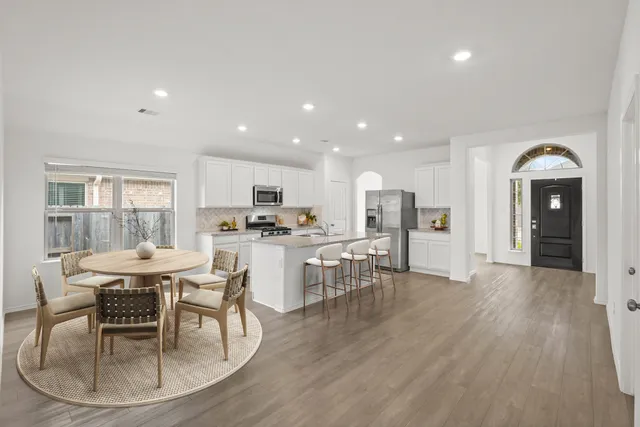 a view of a dining room with furniture and wooden floor