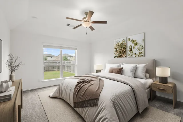 a bedroom with a large bed and a window