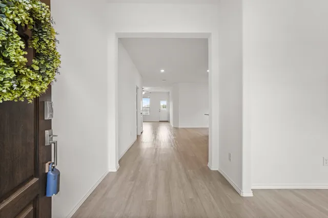 a view of a hallway with wooden floor