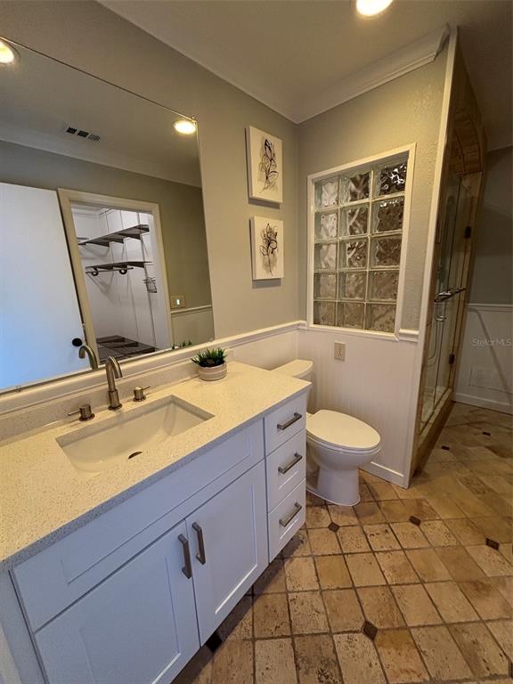9801 Southeast Sunset Harbor Road Summerfield, FL 34491 - Photo 10 of 37 a bathroom with a toilet sink and mirror