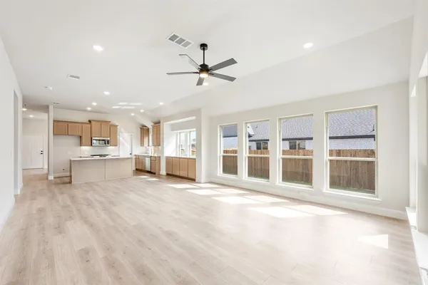 a view of an empty room with a kitchen