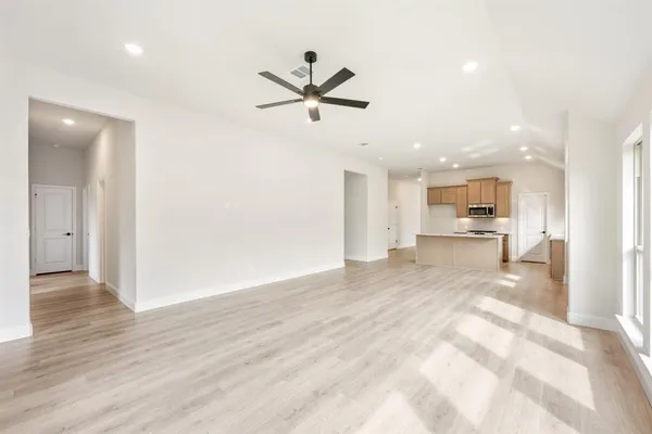 a view of a kitchen with a sink and dishwasher cabinet with wooden floor