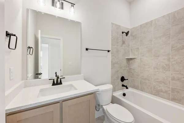 a bathroom with a sink toilet tub and shower