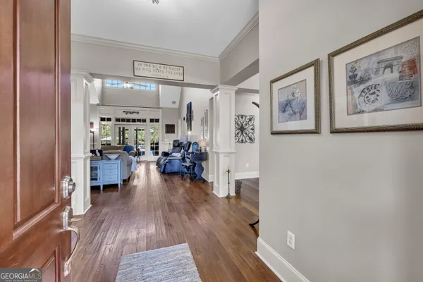 a living room with fireplace furniture and wooden floor