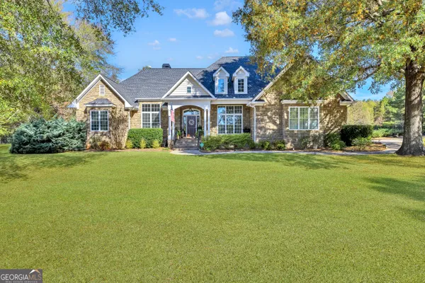 a front view of house with yard and green space