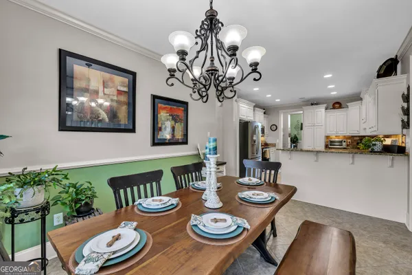a kitchen with granite countertop white cabinets and stainless steel appliances