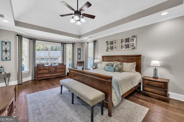 a bedroom with a bed and ceiling fan