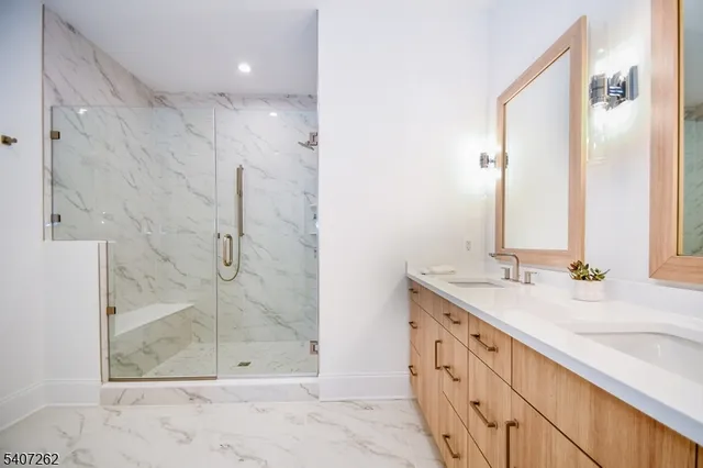 a bathroom with a granite countertop sink mirror and shower