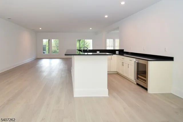 a view of a kitchen with a sink and microwave