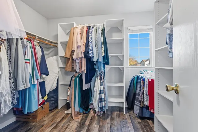 a view of walk in closet with clothes and shoes