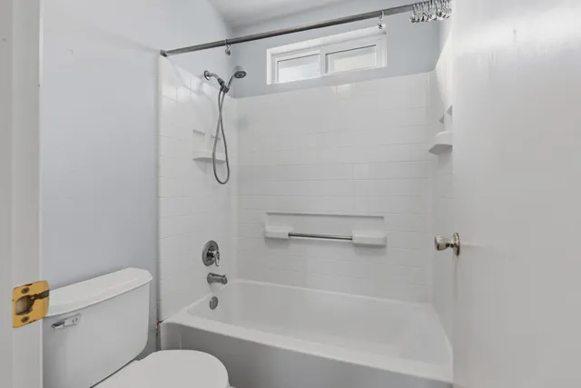 a bathroom with a shower and a toilet