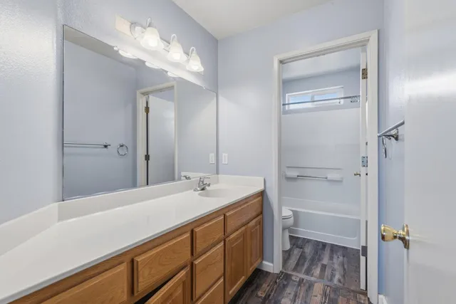 a bathroom with a sink a vanity and a mirror