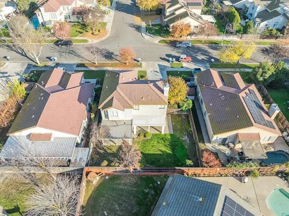an aerial view of residential houses with outdoor space and swimming pool