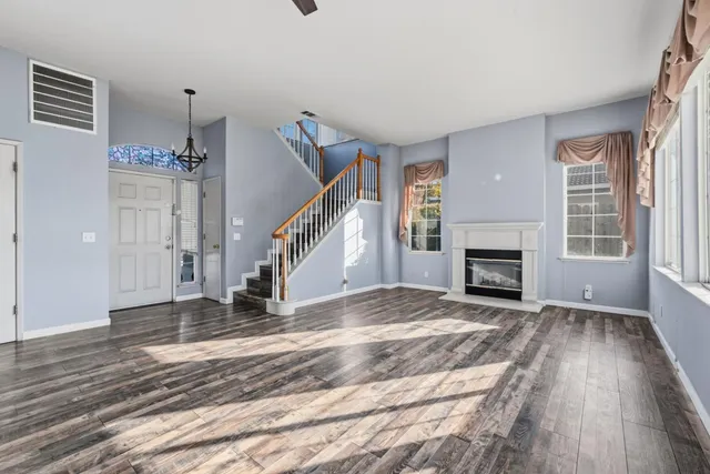 a view of a livingroom with wooden floor and fireplace