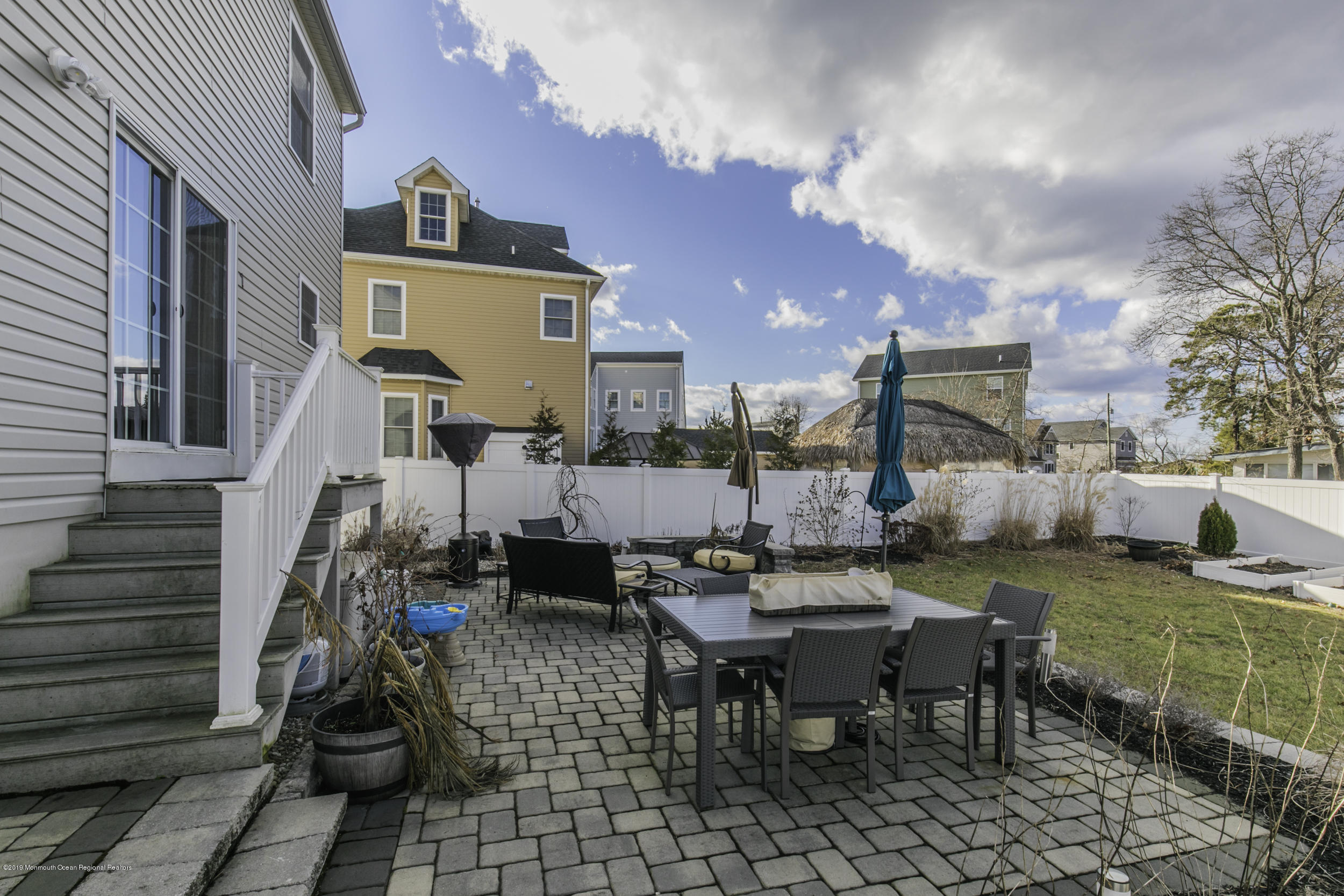 15 Seagoin Road Brick, NJ 08723 - Photo 30 of 32 a view of a patio with table and chairs and potted plants