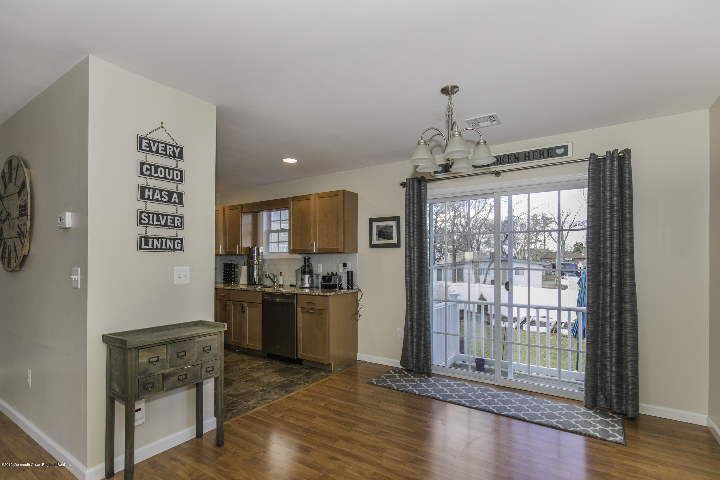 15 Seagoin Road Brick, NJ 08723 - Photo 9 of 32 a view of a kitchen with a stove wooden cabinets and a floor to ceiling window