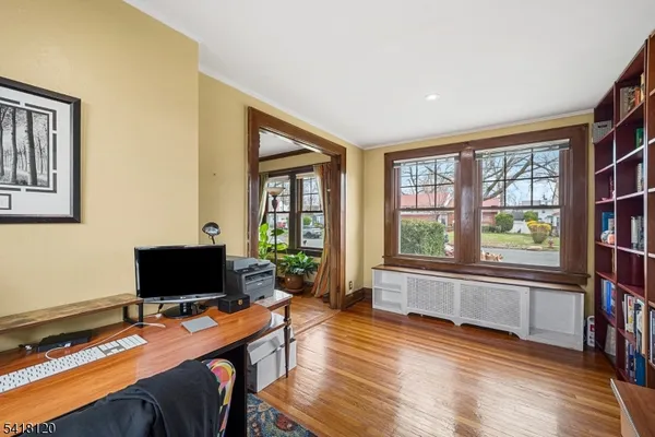 a view of a livingroom with workspace and a window