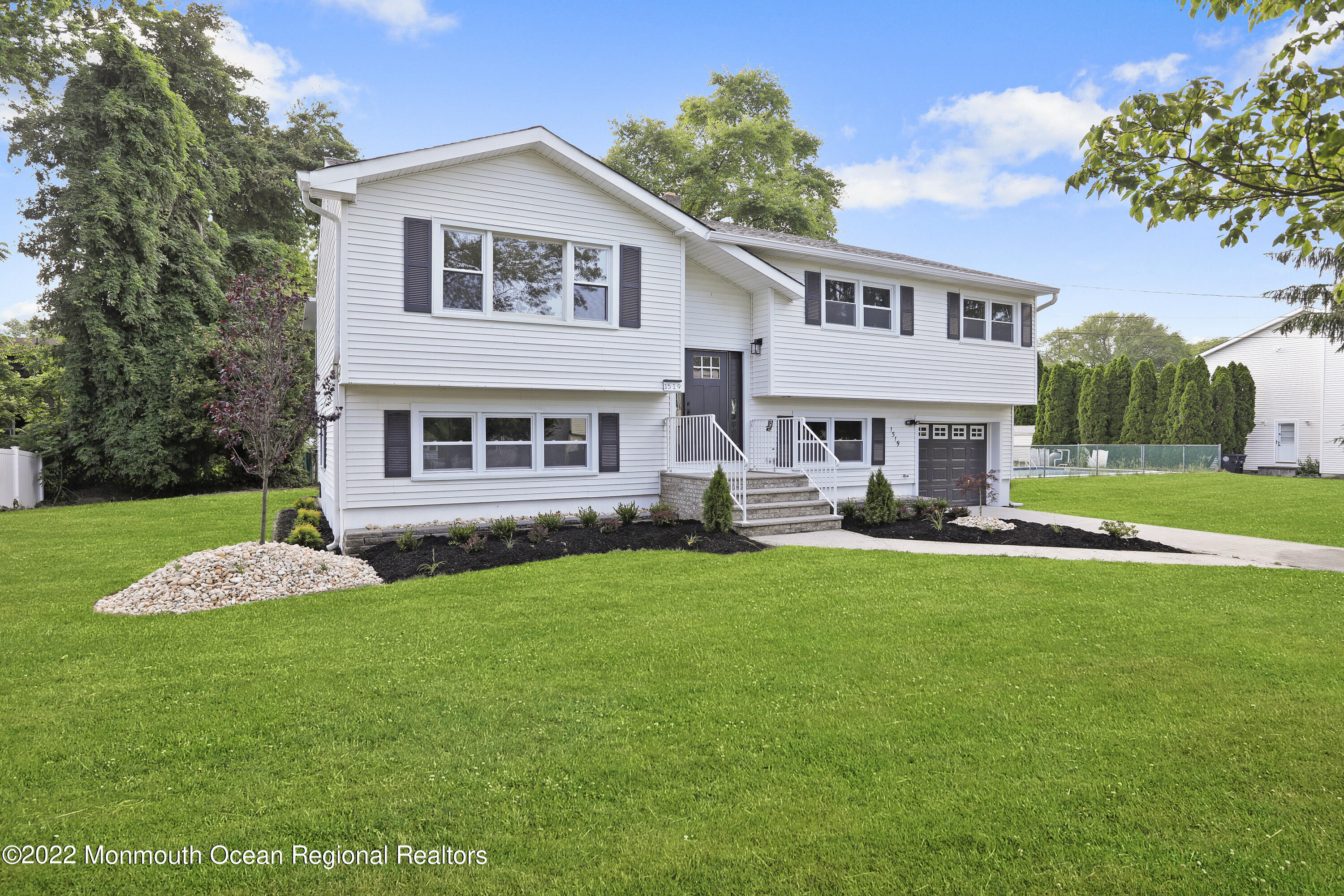 1519 Rogers Road Wall, NJ 07719 - Photo 1 of 38 a front view of a house with a yard and porch