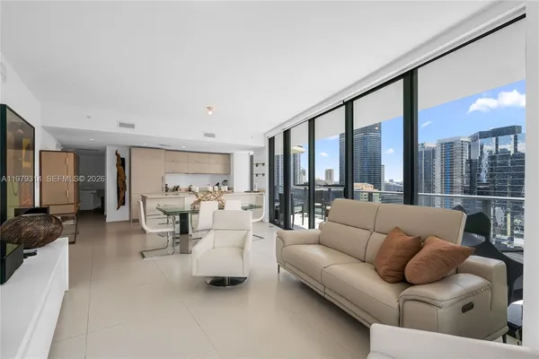 a living room with furniture and a large window