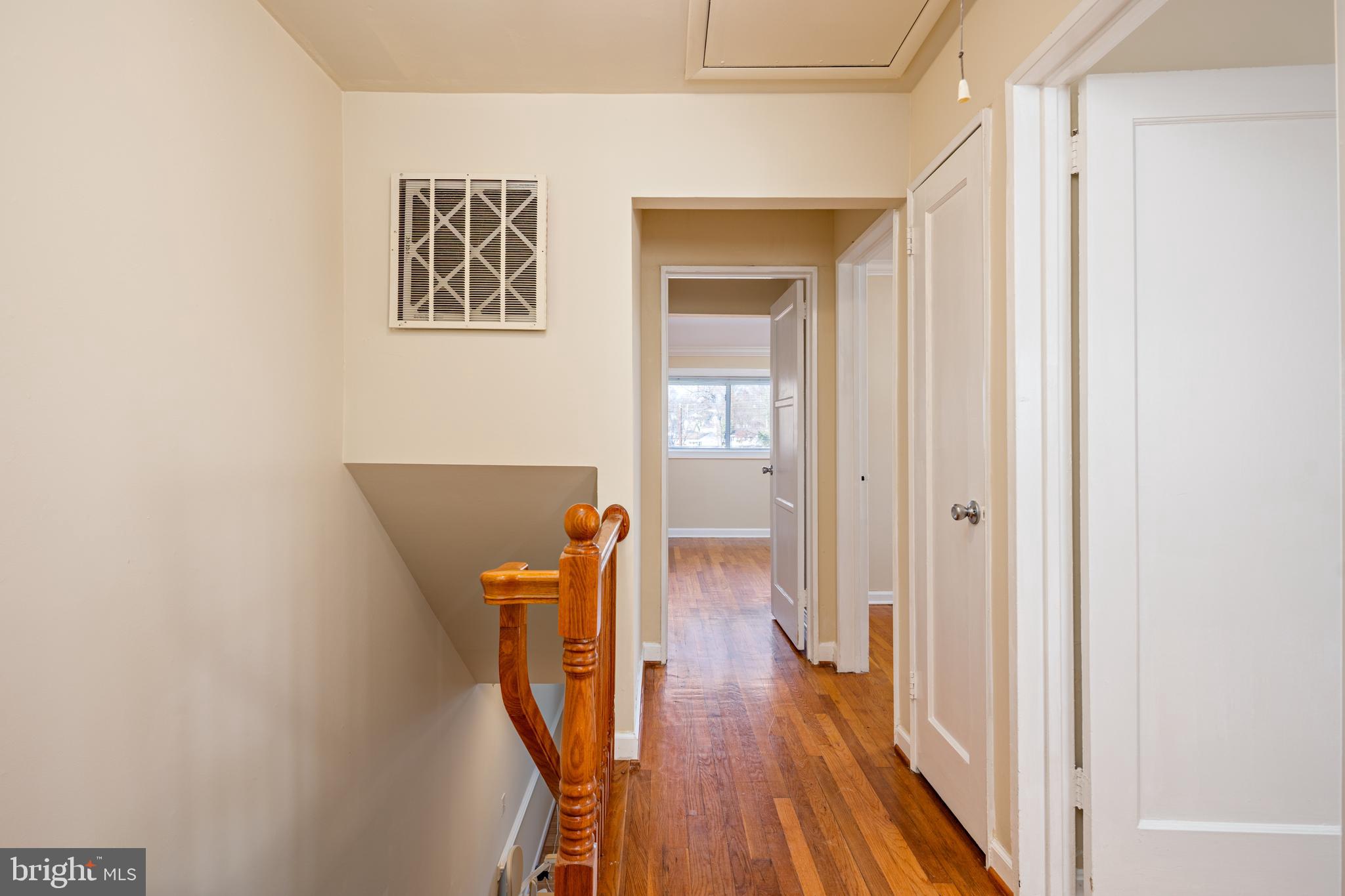 6319 Longfellow Street Riverdale, MD 20737 - Photo 14 of 40 a view of a hallway with wooden floor and a bathroom