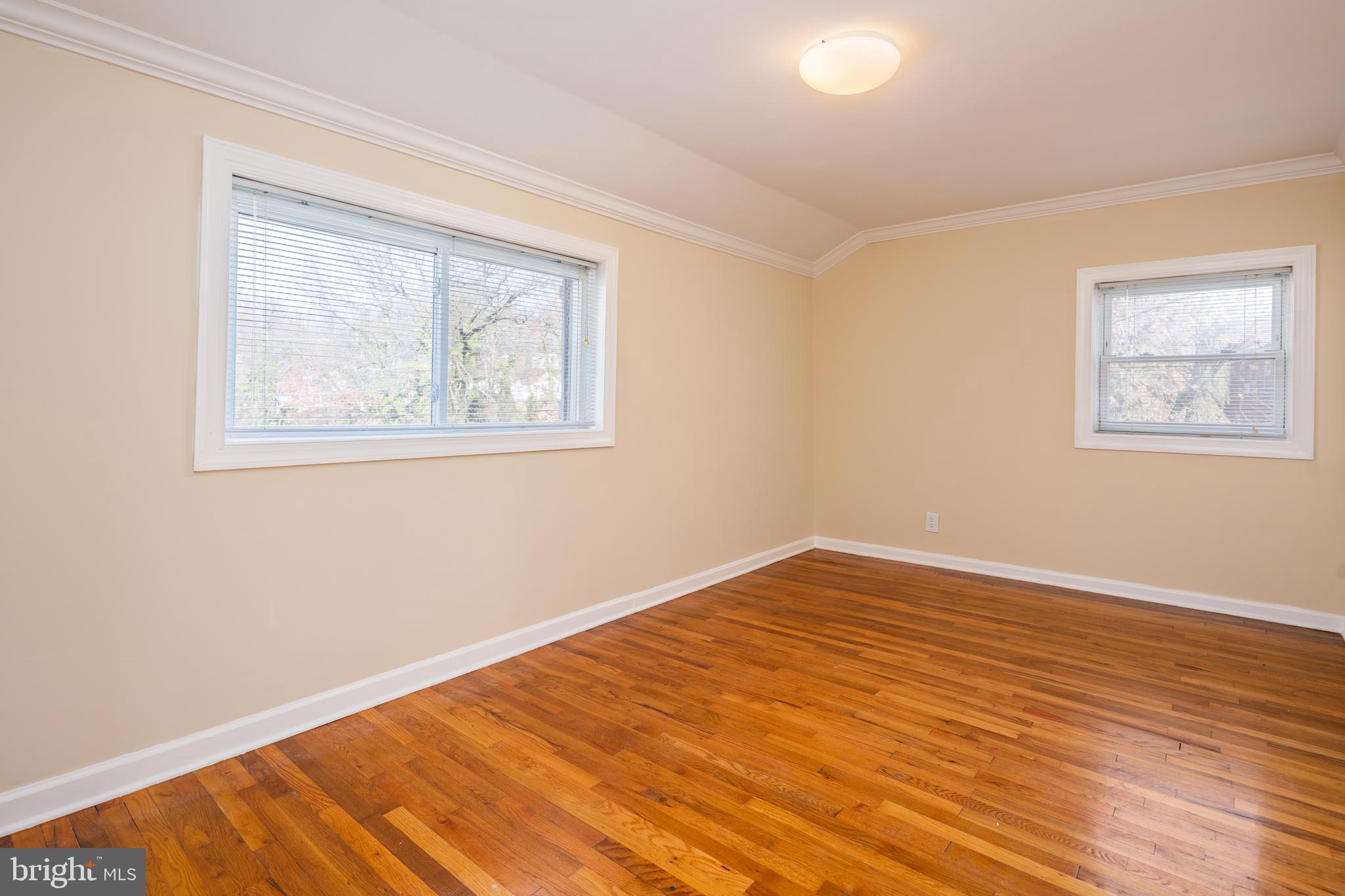 6319 Longfellow Street Riverdale, MD 20737 - Photo 17 of 40 a view of an empty room with wooden floor and a window