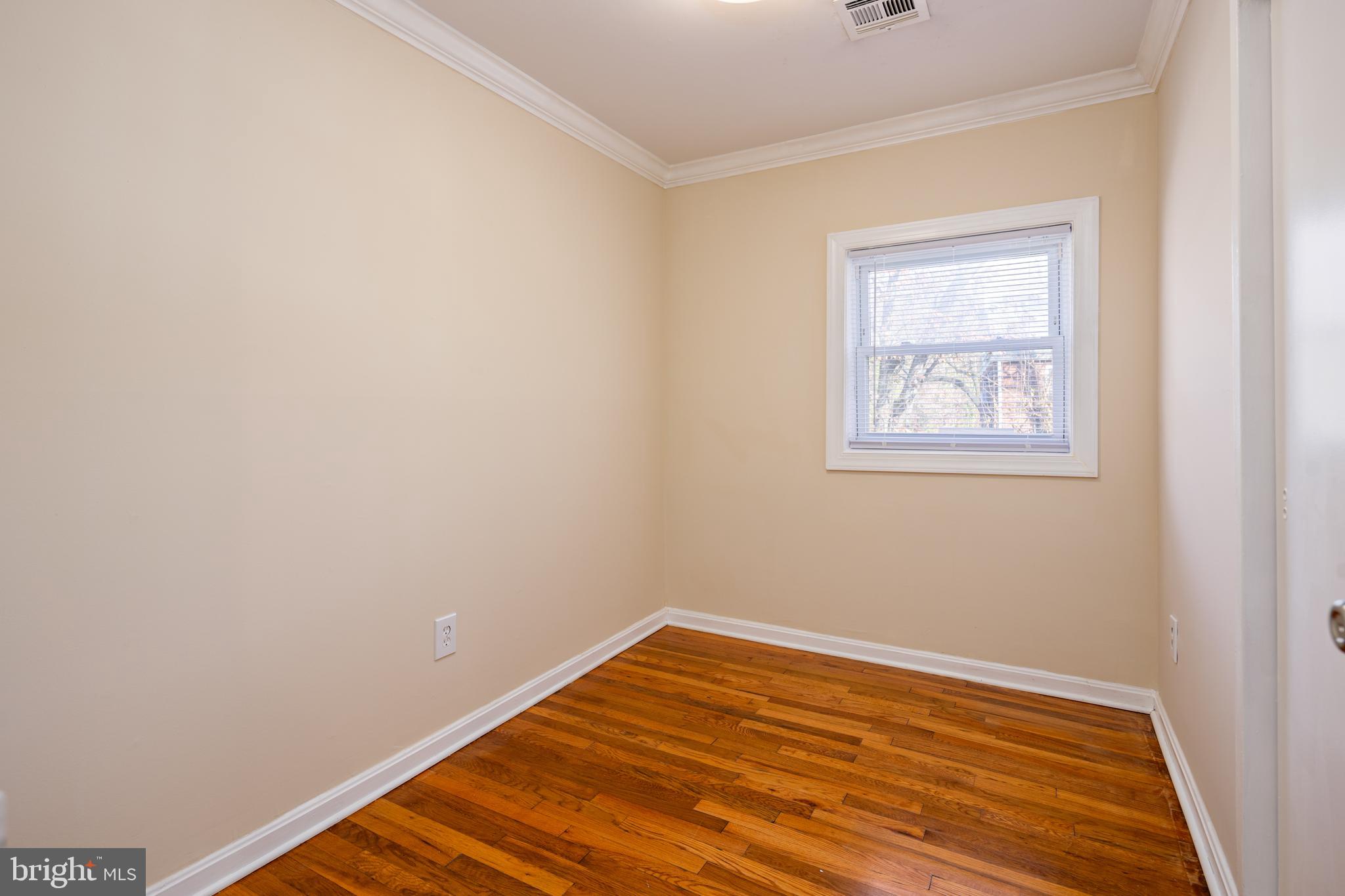 6319 Longfellow Street Riverdale, MD 20737 - Photo 21 of 40 a view of a room with wooden floor and a window