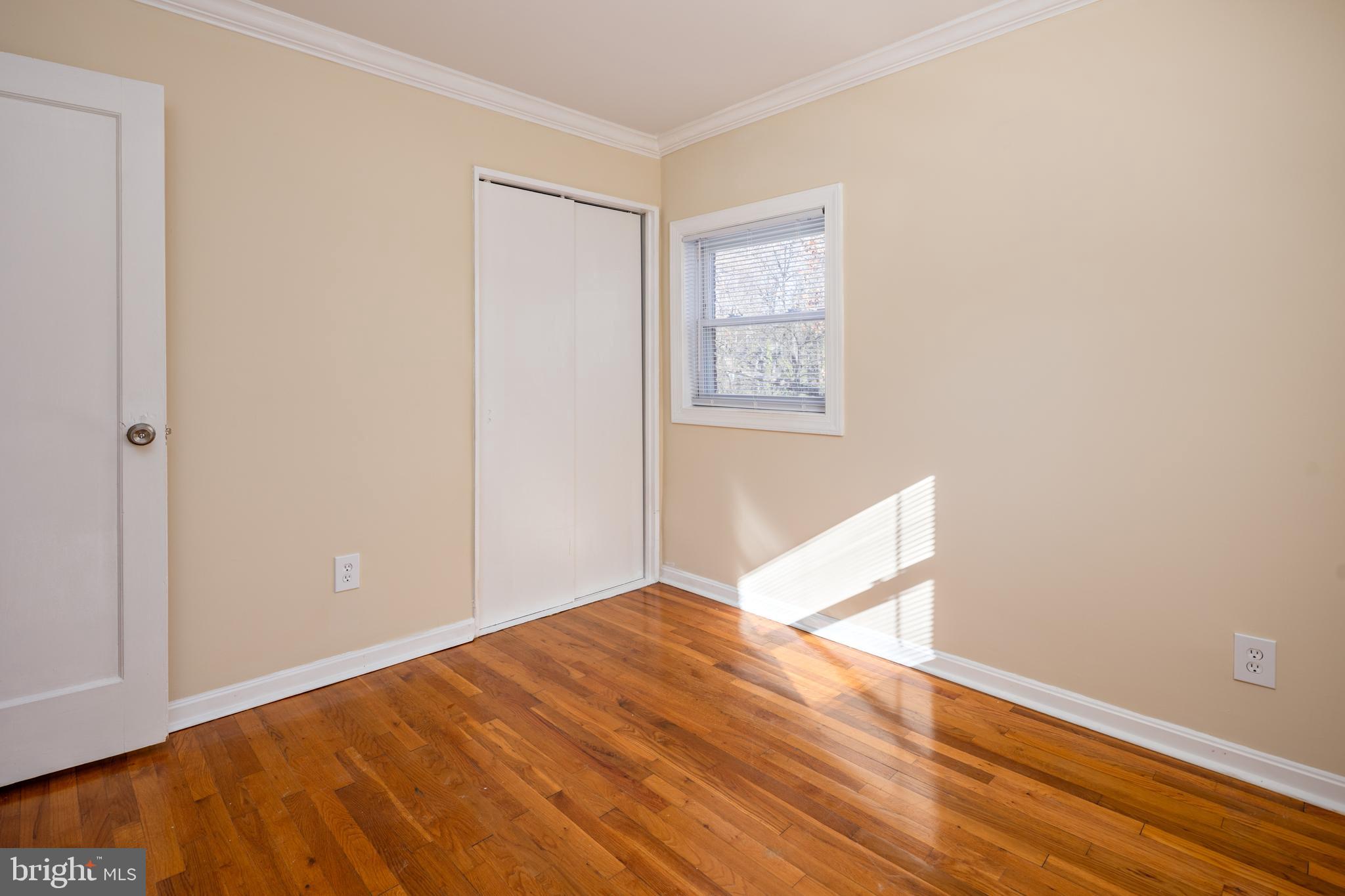 6319 Longfellow Street Riverdale, MD 20737 - Photo 23 of 40 an empty room with wooden floor and windows