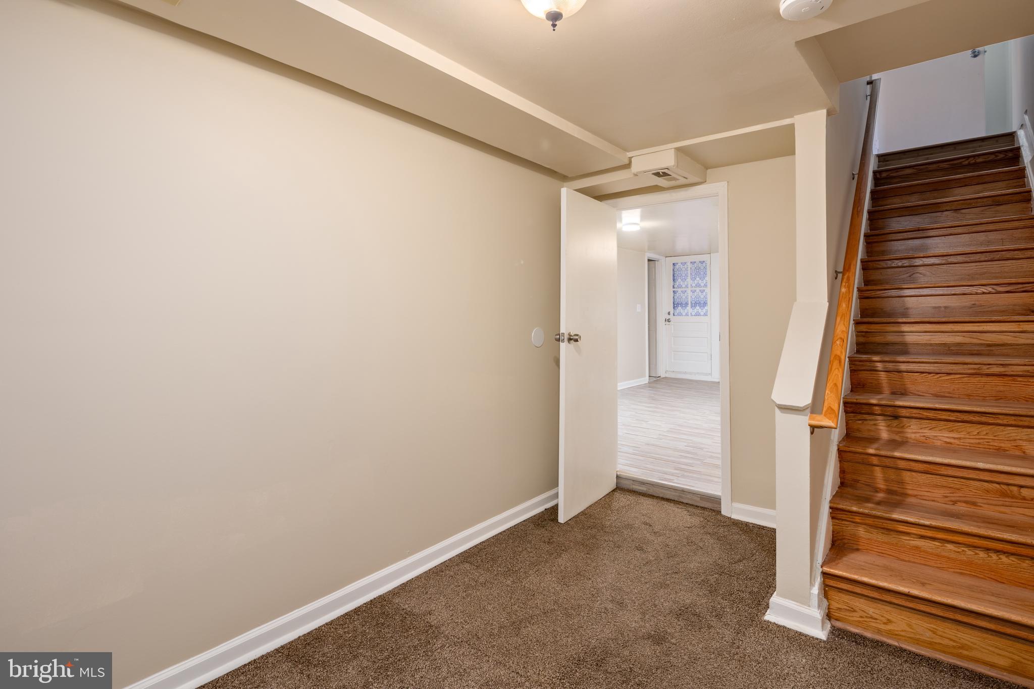 6319 Longfellow Street Riverdale, MD 20737 - Photo 24 of 40 a view of hallway with stairs and a wooden floor