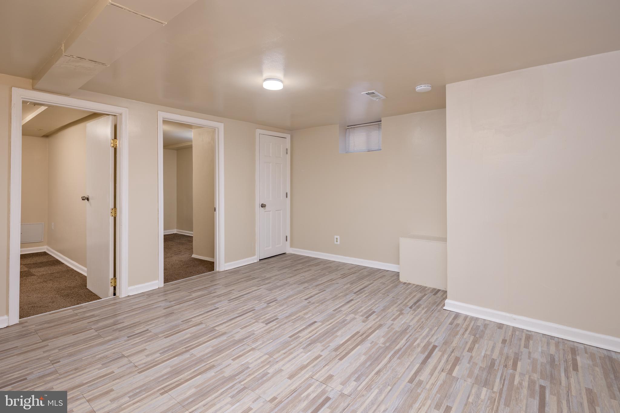 6319 Longfellow Street Riverdale, MD 20737 - Photo 28 of 40 wooden floor in an empty room with a window