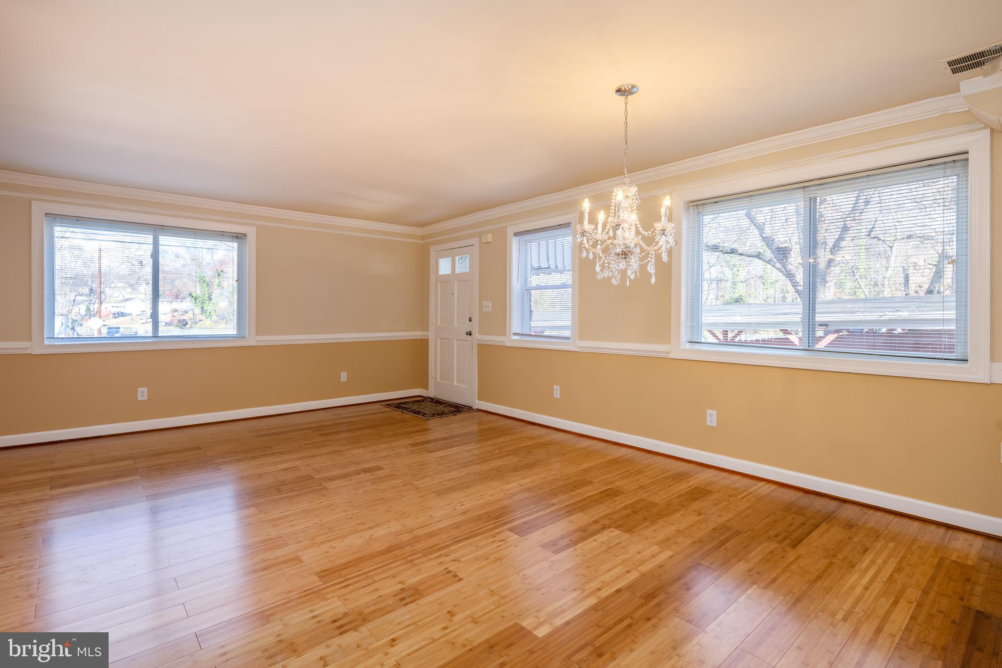 6319 Longfellow Street Riverdale, MD 20737 - Photo 5 of 40 an empty room with wooden floor and windows