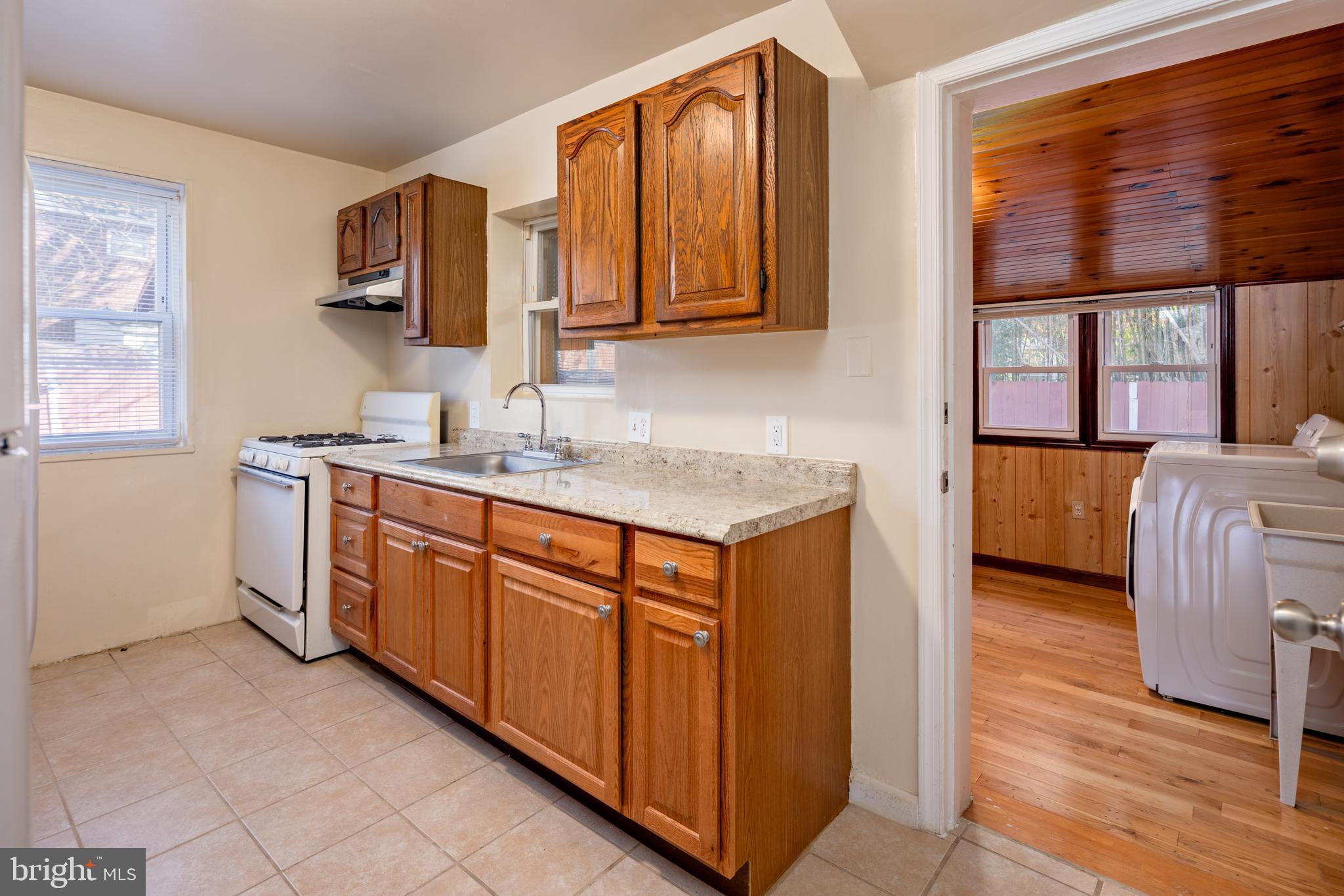 6319 Longfellow Street Riverdale, MD 20737 - Photo 7 of 40 a kitchen with stainless steel appliances granite countertop a sink stove and cabinets
