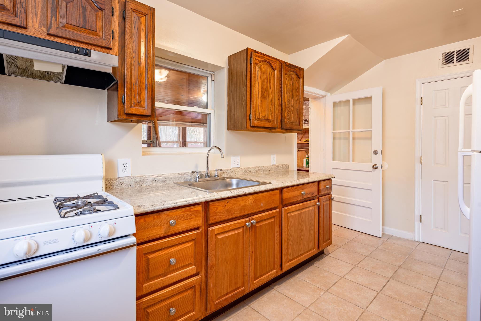 6319 Longfellow Street Riverdale, MD 20737 - Photo 8 of 40 a kitchen with stainless steel appliances granite countertop a sink stove and cabinets