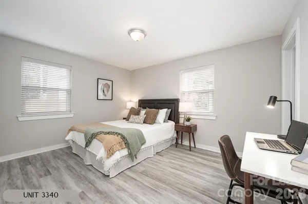 a bedroom with a bed a chair and a window
