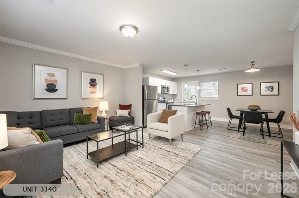 a living room with furniture and view of kitchen
