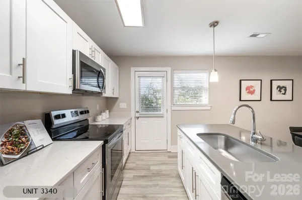 a kitchen that has a sink a stove and window