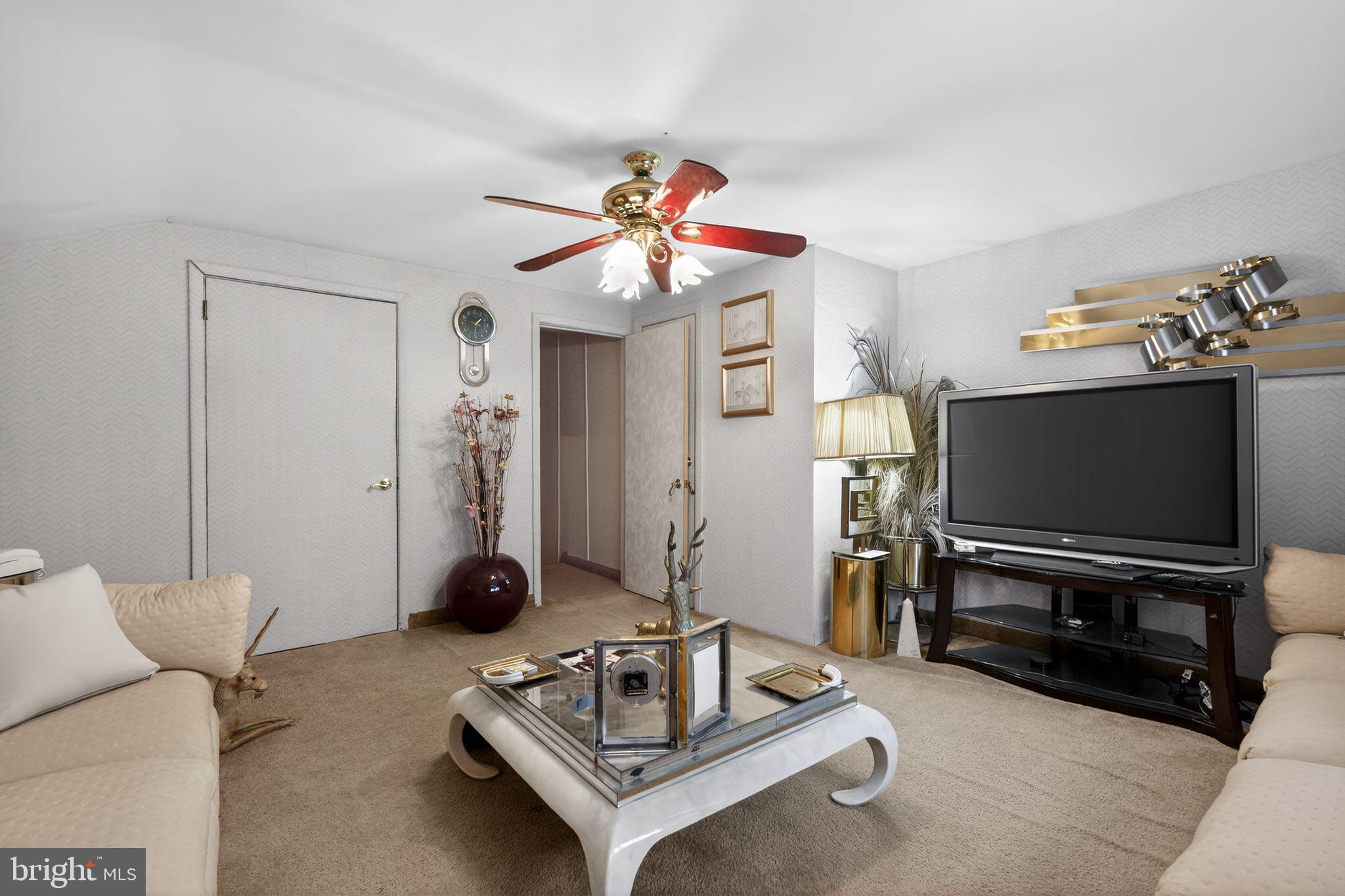 1912 Cobden Road Glenside, PA 19038 - Photo 12 of 30 a living room with furniture a flat screen tv and a window